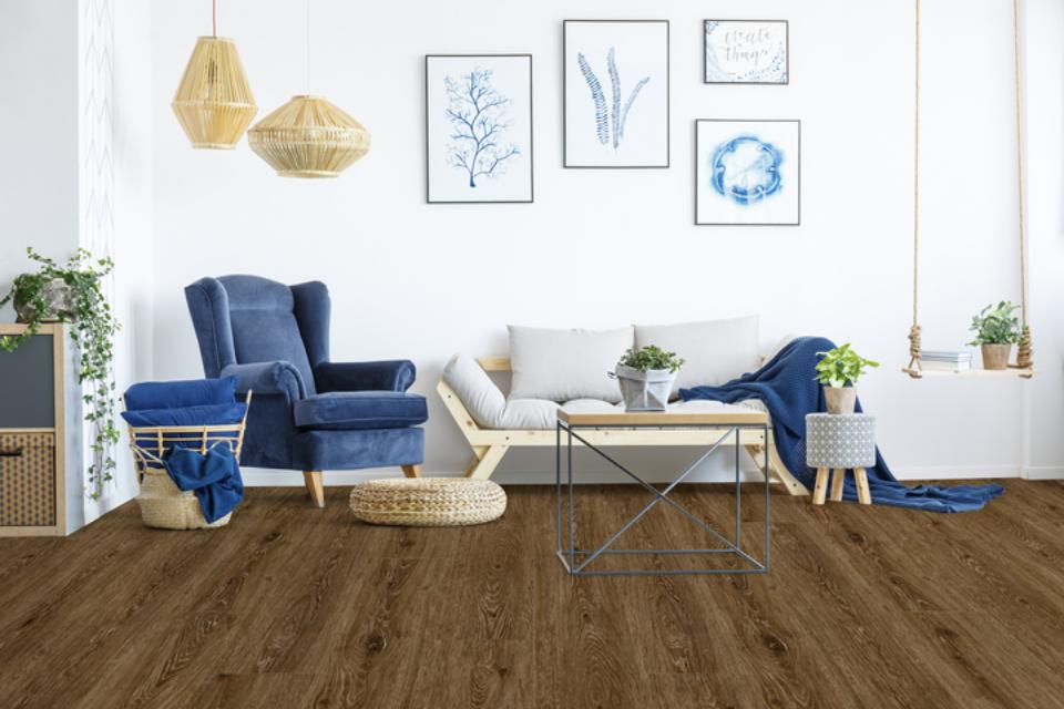 dark wood look flooring in living room with blue decor.